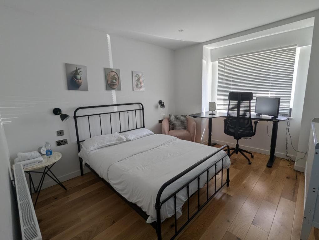 Double bedroom with a desk, office chair and armchair